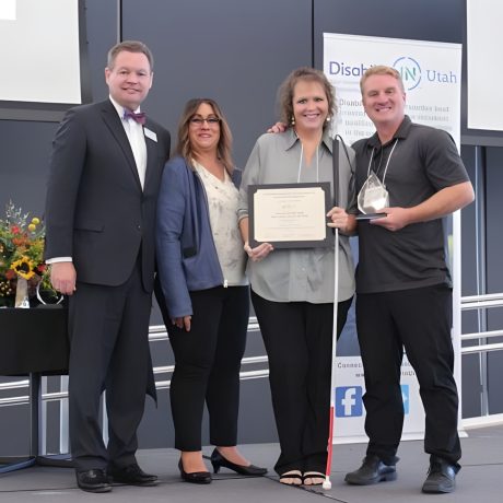 Steven Olson and Leah Lobato present Laura Summerhays and Scott Nielson the Golden Key Award on behalf of Zion Jellystone Park, Salt Lake City, Utah, date not specified.